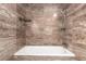 Tranquil bathroom with decorative tiled walls and a tub/shower combination for a spa-like experience at 2101 S Victor St # C, Aurora, CO 80014