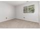 Bright bedroom features neutral carpet, a window with blinds, and freshly painted walls at 2101 S Victor St # C, Aurora, CO 80014
