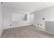 Well-lit bedroom featuring neutral color plush carpet, a view of the stairs and a white door at 2101 S Victor St # C, Aurora, CO 80014