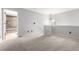 Cozy bedroom area with neutral plush carpet, chandelier lighting and access to a bathroom with a shower at 2101 S Victor St # C, Aurora, CO 80014