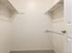 Neat walk-in closet with carpet floor and white shelves, perfect for organizing your wardrobe at 2101 S Victor St # C, Aurora, CO 80014