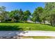 View of grassy common area with mature landscaping and tree cover in neighborhood at 2101 S Victor St # C, Aurora, CO 80014