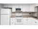 Bright kitchen featuring white appliances, cabinetry, tiled backsplash and tile floors at 2101 S Victor St # C, Aurora, CO 80014
