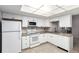 Bright kitchen featuring white appliances, cabinetry, tiled backsplash and tile floors at 2101 S Victor St # C, Aurora, CO 80014