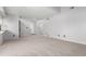 Spacious living room with plush carpet, neutral paint, white trim, and entry door with a sidelight at 2101 S Victor St # C, Aurora, CO 80014
