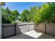 Cozy fenced patio with mature landscaping and a view of the neighborhood street at 2101 S Victor St # C, Aurora, CO 80014