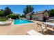 Community pool with lounge chairs and tables for relaxing on a hot day at 2101 S Victor St # C, Aurora, CO 80014