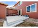 Backyard patio featuring outdoor seating, planters, and access to the home's interior at 11034 Nome St, Commerce City, CO 80640