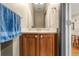 Bathroom featuring modern fixtures, a wood vanity, and neutral decor at 11034 Nome St, Commerce City, CO 80640