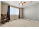 Relaxing bedroom with neutral carpet, a large bright window, and a comfortable rocking chair at 11034 Nome St, Commerce City, CO 80640