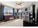 Spacious walk-in closet with custom shelving, hanging racks, natural light, and ceiling fan at 11034 Nome St, Commerce City, CO 80640