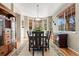 Charming dining room with wood floors, built-in cabinets, large windows, and ample seating at 11034 Nome St, Commerce City, CO 80640