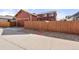 Home exterior displaying a fenced backyard with stone detail at 11034 Nome St, Commerce City, CO 80640