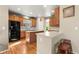 Open kitchen with wood cabinetry, a center island, and breakfast bar perfect for entertaining guests at 11034 Nome St, Commerce City, CO 80640