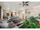 Open-concept living area with a hardwood floor seamlessly connected to the dining area and kitchen at 11034 Nome St, Commerce City, CO 80640