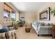 Inviting living room featuring plush seating, neutral tones, and ample natural light from large windows at 11034 Nome St, Commerce City, CO 80640