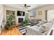 Bright living room featuring a fireplace, built-in shelves, hardwood floors, and large windows at 11034 Nome St, Commerce City, CO 80640