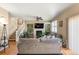 Comfortable living room with fireplace, built-in shelves, and plenty of natural light from the large windows at 11034 Nome St, Commerce City, CO 80640