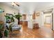 Open-concept space featuring a stylish kitchen with a cozy sitting area and hardwood floors at 11034 Nome St, Commerce City, CO 80640