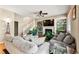 Cozy living room with a fireplace, built-in shelves, ceiling fan, and comfortable seating area at 11034 Nome St, Commerce City, CO 80640