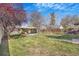 Well-maintained backyard with lush green grass and mature trees at 4476 S Lincoln St, Englewood, CO 80113