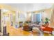 Bright living room with hardwood floors, a neutral sofa, and an orange accent chair at 4476 S Lincoln St, Englewood, CO 80113