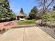 A landscaped backyard with grass, rock features, concrete patio, and a small gazebo at 3986 S Bahama St, Aurora, CO 80013