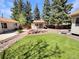 A well kept backyard with rock features, artificial grass, and a small shed or office at 3986 S Bahama St, Aurora, CO 80013