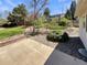 Landscaped backyard featuring a mix of green grass, bushes, rock features and a concrete patio at 3986 S Bahama St, Aurora, CO 80013