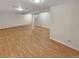 Spacious basement featuring wood style flooring and support beams at 3986 S Bahama St, Aurora, CO 80013