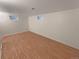 Bright basement featuring wood style flooring and small windows at 3986 S Bahama St, Aurora, CO 80013