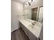 Bright bathroom with white cabinets and a shower with glass door at 3986 S Bahama St, Aurora, CO 80013