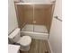 Compact bathroom featuring a toilet, tub with shower, and towel rack at 3986 S Bahama St, Aurora, CO 80013