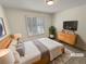 Calm bedroom with a wooden frame bed, neutral colors, and lots of natural light at 3986 S Bahama St, Aurora, CO 80013