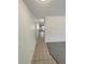 Hallway with tiled floors leading to carpeted area and natural light at 3986 S Bahama St, Aurora, CO 80013