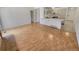 Open-concept living room with hardwood floors and view of kitchen with breakfast bar at 3986 S Bahama St, Aurora, CO 80013