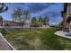 Large backyard with a brick and stone wall offering privacy and a touch of elegance at 9552 E Silent Hills Pl, Lone Tree, CO 80124
