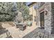 Inviting outdoor patio with a stone fireplace and comfortable seating, surrounded by greenery at 9552 E Silent Hills Pl, Lone Tree, CO 80124