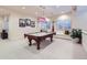 Basement recreation room featuring a pool table, custom window seats, and bright lighting at 9552 E Silent Hills Pl, Lone Tree, CO 80124