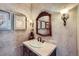 Charming powder room with a decorative mirror, sconce lighting, and textured wall at 9552 E Silent Hills Pl, Lone Tree, CO 80124
