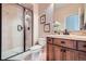 This bathroom has a tiled shower with glass doors, a toilet, and a wooden vanity with light countertops at 9552 E Silent Hills Pl, Lone Tree, CO 80124