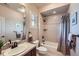 Well-lit bathroom featuring a sink with dark wood cabinets and a bathtub with shower at 9552 E Silent Hills Pl, Lone Tree, CO 80124