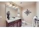 This bathroom has a mirror, vanity with dark wood cabinets, toilet, and decorative wall art at 9552 E Silent Hills Pl, Lone Tree, CO 80124