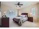 Bright bedroom with a ceiling fan, multiple windows, and wood accents at 9552 E Silent Hills Pl, Lone Tree, CO 80124