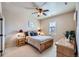 Comfortable bedroom with ceiling fan, two bedside tables and natural light at 9552 E Silent Hills Pl, Lone Tree, CO 80124