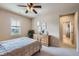 Cozy bedroom with a ceiling fan, large window, and en-suite bathroom access at 9552 E Silent Hills Pl, Lone Tree, CO 80124