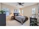 Well-lit bedroom featuring two windows, ceiling fan, and simple decor at 9552 E Silent Hills Pl, Lone Tree, CO 80124