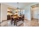 Inviting dining room featuring a wooden table, seating for six, and stylish decor at 9552 E Silent Hills Pl, Lone Tree, CO 80124