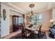 Chic dining room featuring a large table, china cabinet, and elegant chandelier at 9552 E Silent Hills Pl, Lone Tree, CO 80124