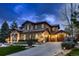 Charming home exterior with stone accents, a spacious driveway, and well-maintained landscaping at 9552 E Silent Hills Pl, Lone Tree, CO 80124
